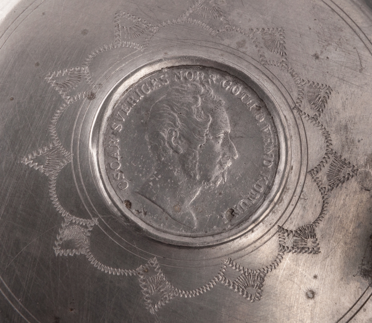 I botten svisselerat "S.F.F.S".
På sidorna blommor, krona, m.m. 
Märkning: Oval under med påbörjade bokstäver: "I..."
På locket mynt med Oskar I:s bild.
Dubbelstämplad med "GS"
Stämplad: "R4"=1847