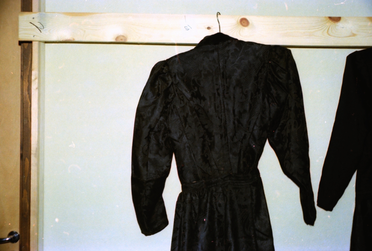 En kjole i svart damask med fløyelkrage (Kalmarkjole?) fra Signe Strømme, Uri. Motiv tatt ved ei tekstilutstilling i Valldal.
