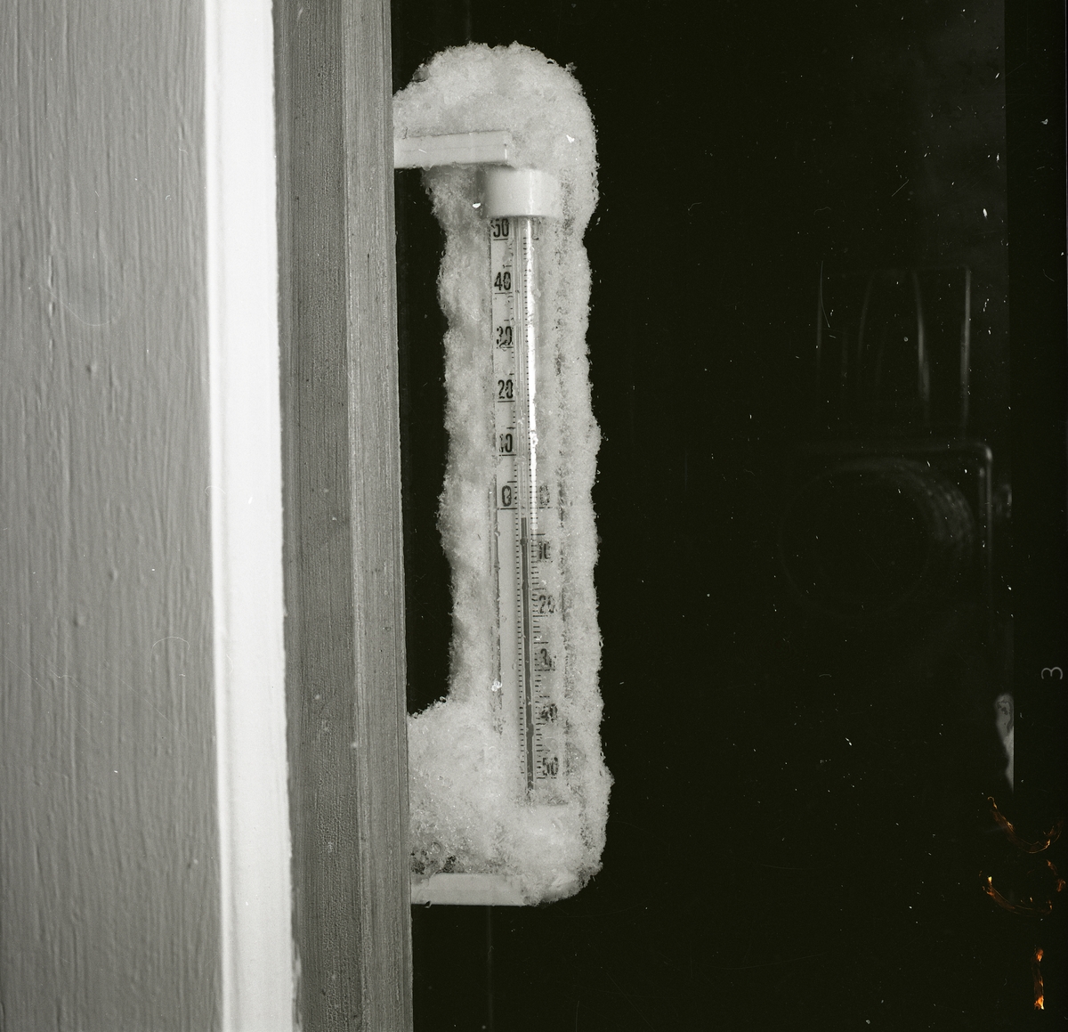 Översnöad utetermometer som visar några minusgrader, 1962.