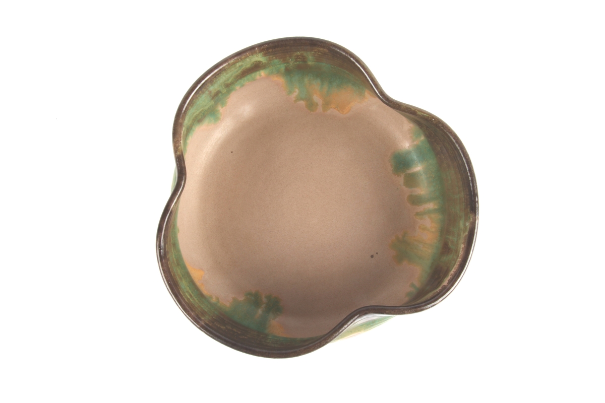 Glasert keramikkskål med utvendige riller og bølget kant.
