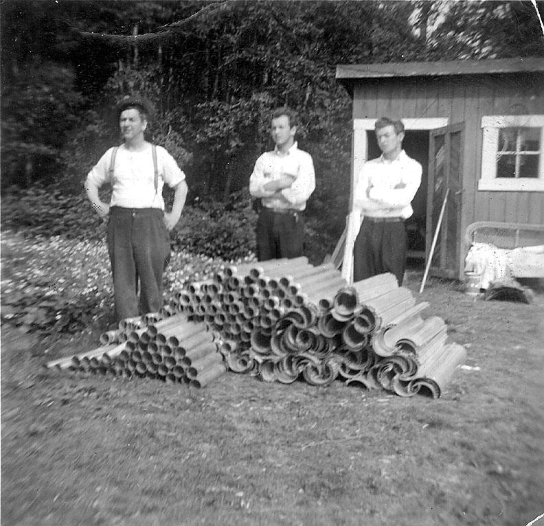 Gutter work. Karl Magnus Karlsen and his two sons out on a job, ca. 1950.
