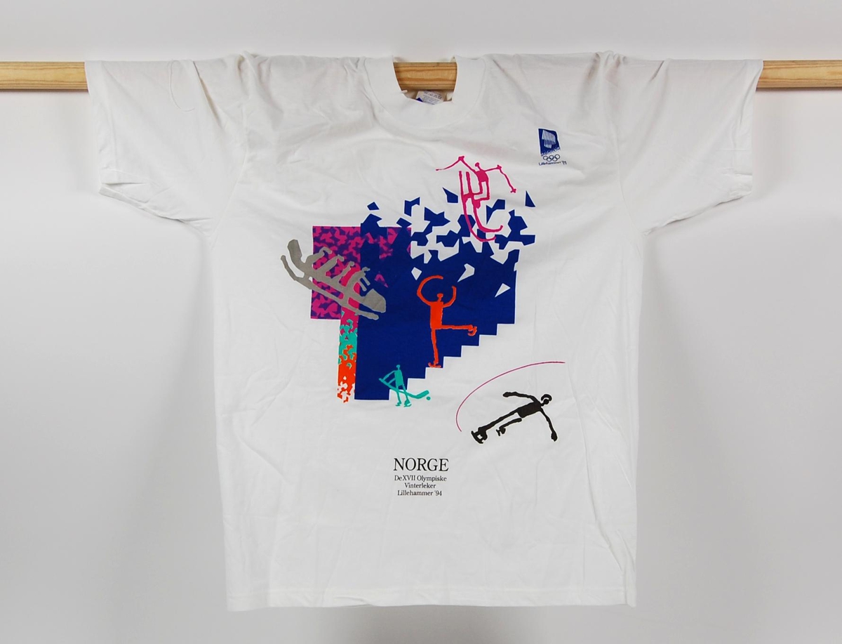 Hvit t-skjorte med flerfarget krystallmønster og piktogrammer av ulike grener i de olympiske vinterleker på Lillehammer i 1994. Krystallmønsteret inngikk i LOOCs designprogram. Det er også en logo for de olympiske vinterleker på Lillehammer i 1994. T-skjorten er i størrelse medium.