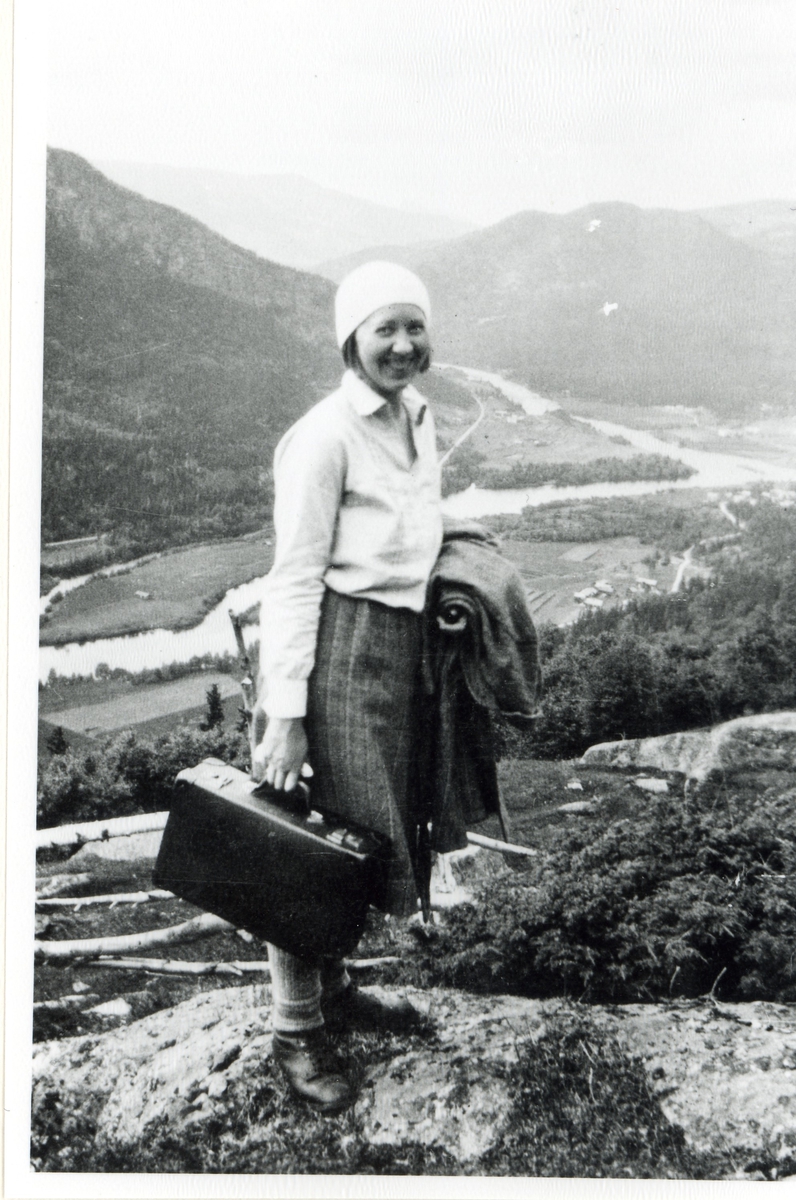 Portrett,koffert,skjørt og jakke.