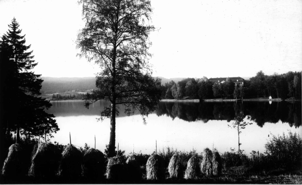 Bogstad gård ca. 1923. Bogstadvannet. Hovedbygnigen med parken i bakgrunnen. Kornstaur i forgrunnen.