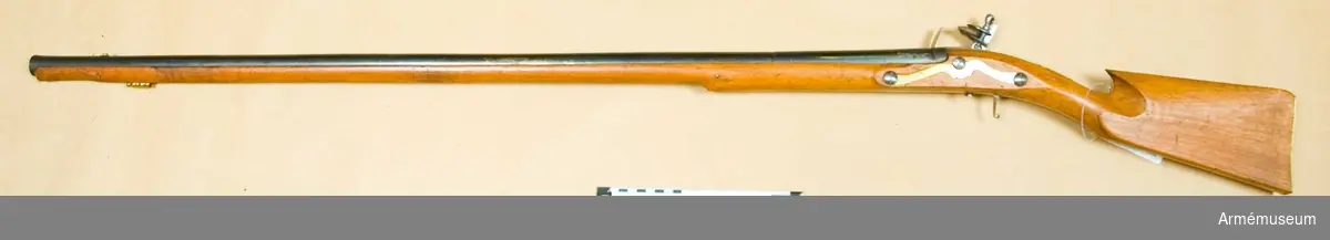 Grupp E XIV.
Loppets relativa längd 49,2 kal. Afrikanskt gevär med flintlås. Pipan är blåanlöpt. Varbygel,  mellan- och spetsrörkor samt laddstock fattas. I'Annely. 