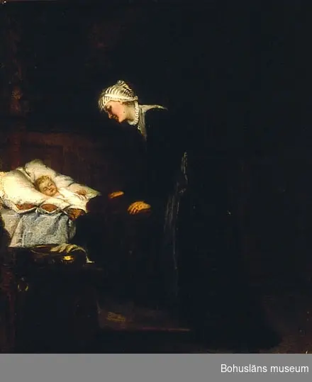 Kvinna lutar sig över ett sovande barn i en säng.